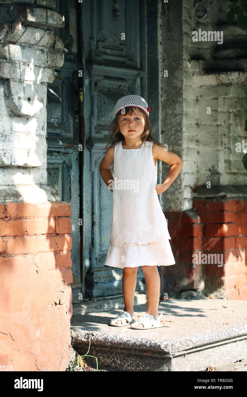 Little girl stands in front of the door Stock Photo - Alamy