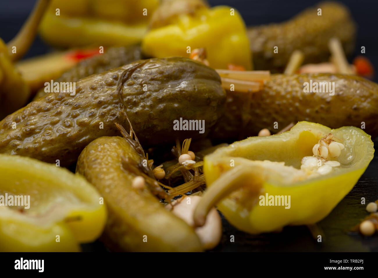 Cornichons Mini French Style Gherkin Cucumbers And Pickled Pepperoncini Peppers On Natural Stone Background Stock Photo Alamy