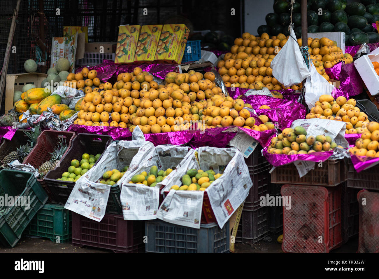 A roadside fruit shop selling mangoes,papaya during summer in Hyderabad,India Stock Photo