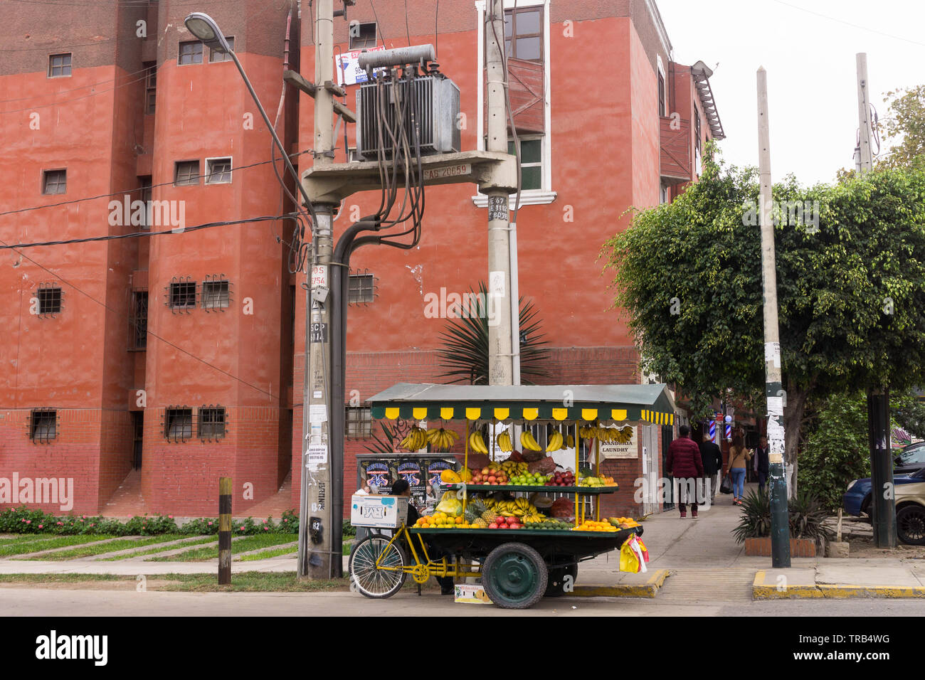 Barranco (Lima) street scene - a street cart with fruits below a pole mounted transformer, Peru. Stock Photo