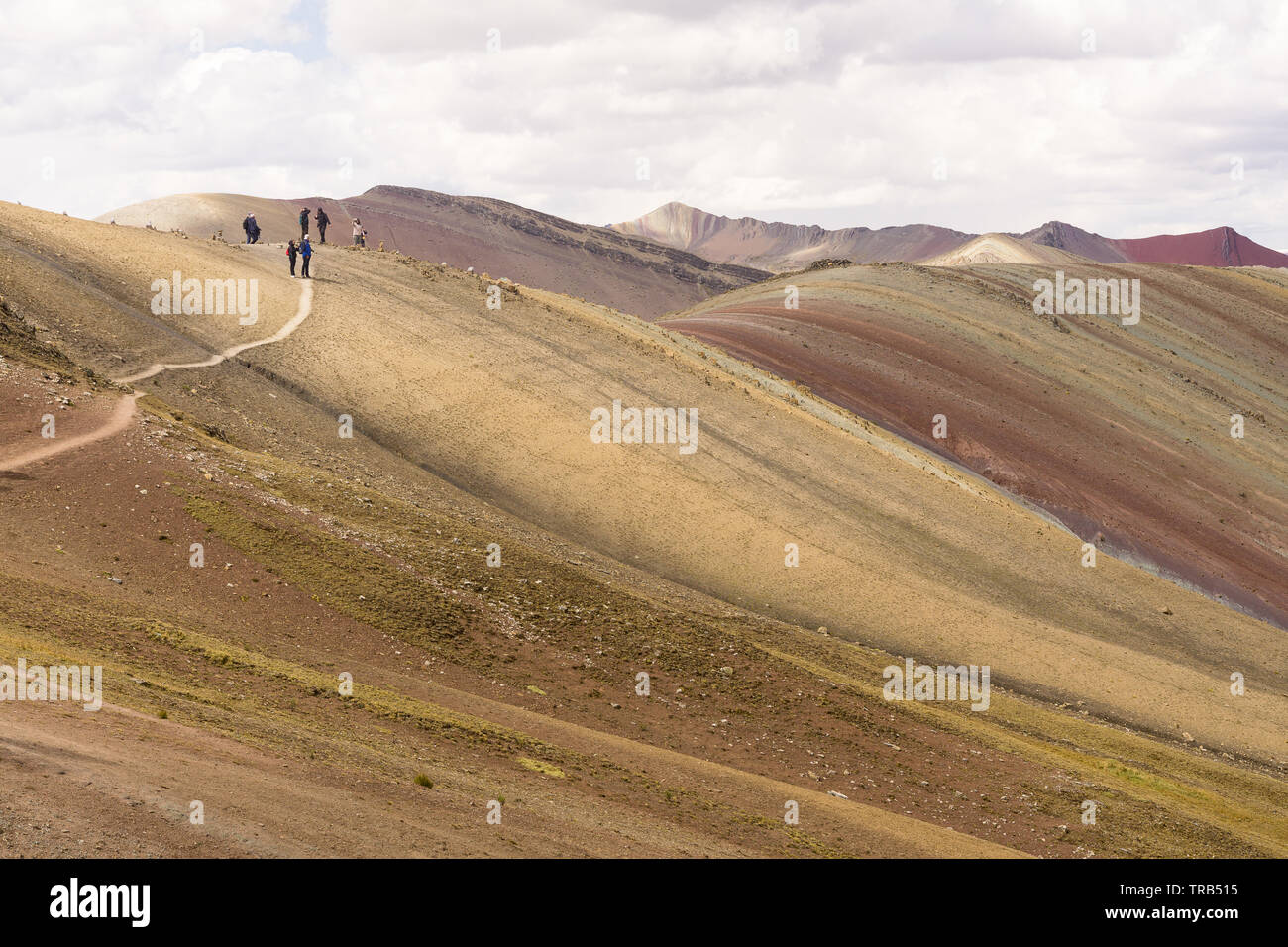 Peru Palccoyo Mountain (alternative Rainbow Mountain) - People trekking along the slopes of the colorful Palccoyo Mountain in Peru, South America. Stock Photo