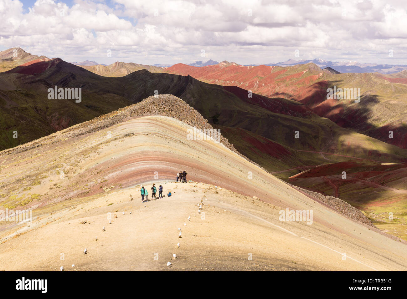 Peru Palccoyo Mountain (alternative Rainbow Mountain) - People trekking along the slopes of the colorful Palccoyo Mountain in Peru, South America. Stock Photo