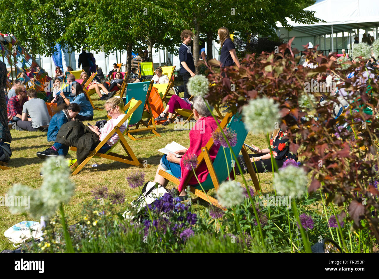 Visitors relaxing in the garden area at Hay Festival Hay on Wye Powys Wales UK Stock Photo