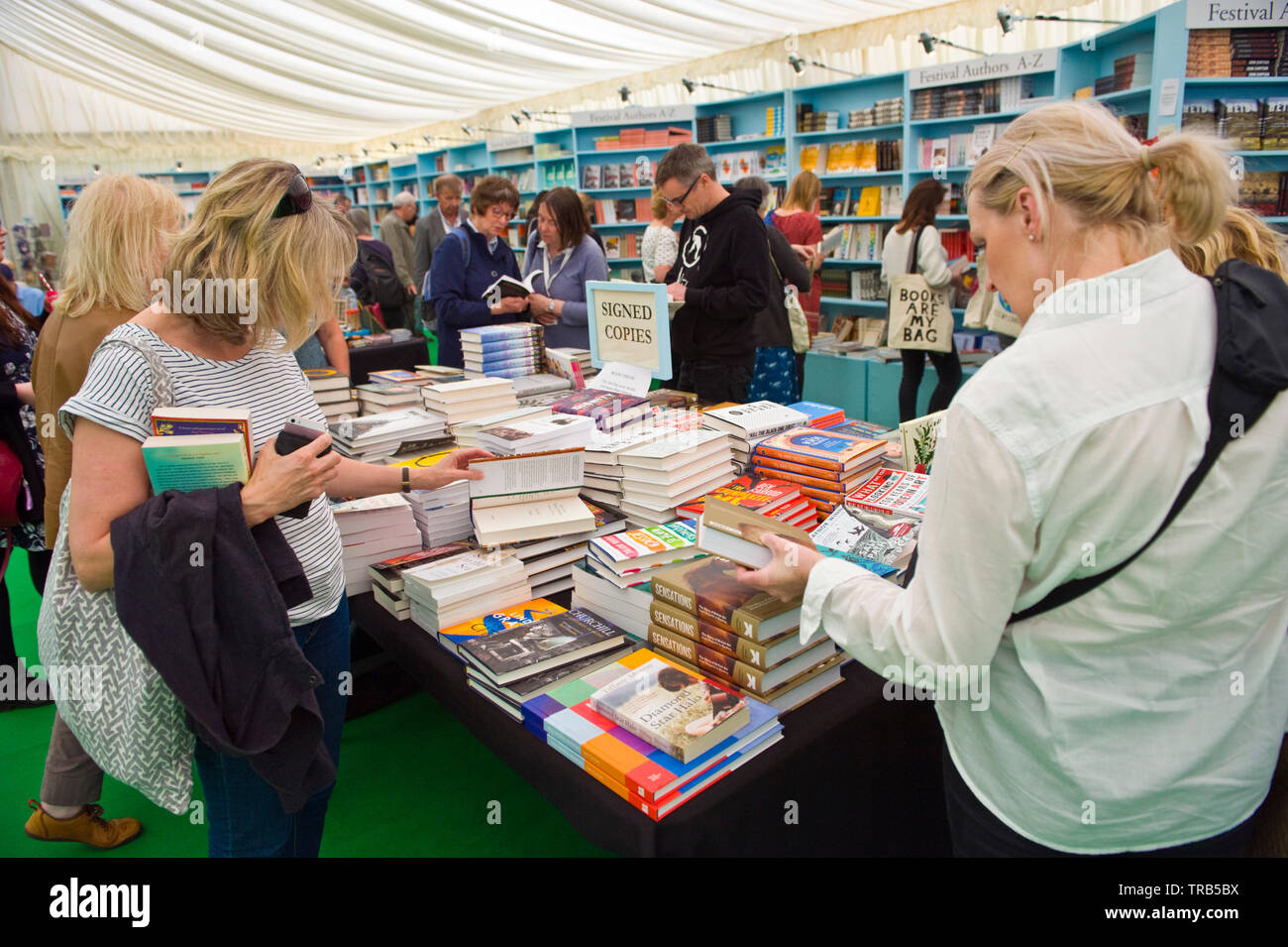 Visitors browsing author signed copies of books in the bookstore at Hay Festival Hay on Wye Powys Wales UK Stock Photo