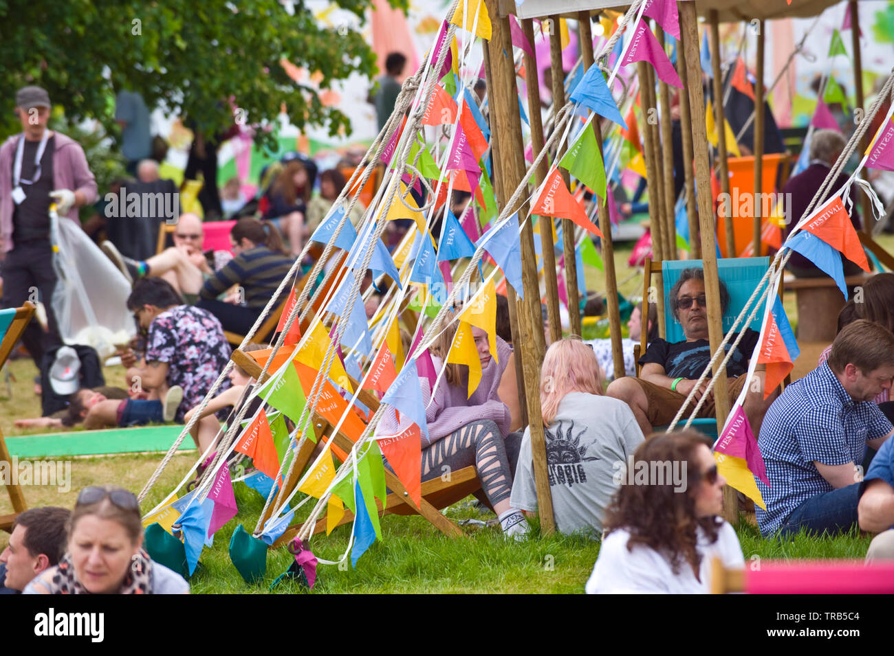 Visitors relaxing at the marquee on the lawn in the garden during Hay Festival Hay on Wye Powys Wales UK Stock Photo