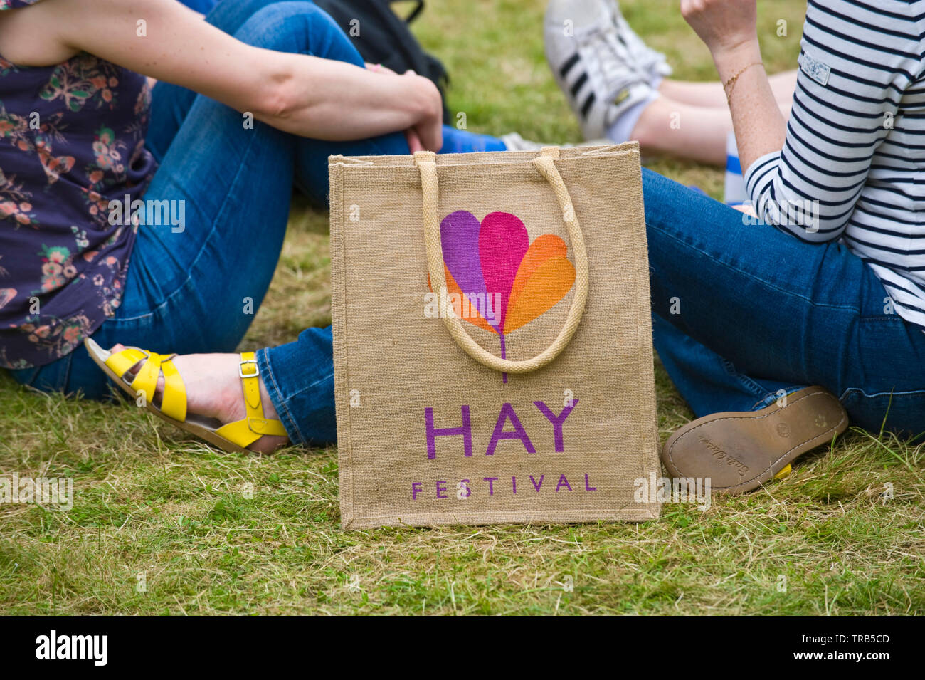 Visitors relaxing on the lawn at Hay Festival Hay on Wye Powys Wales UK Stock Photo