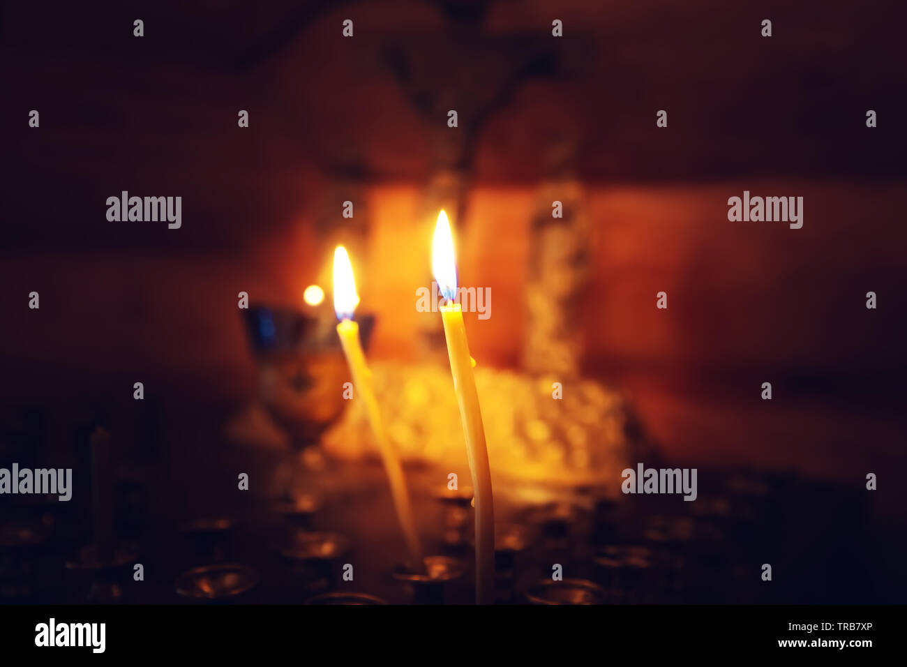 Church candles in front of the cross. The interior of the church, the