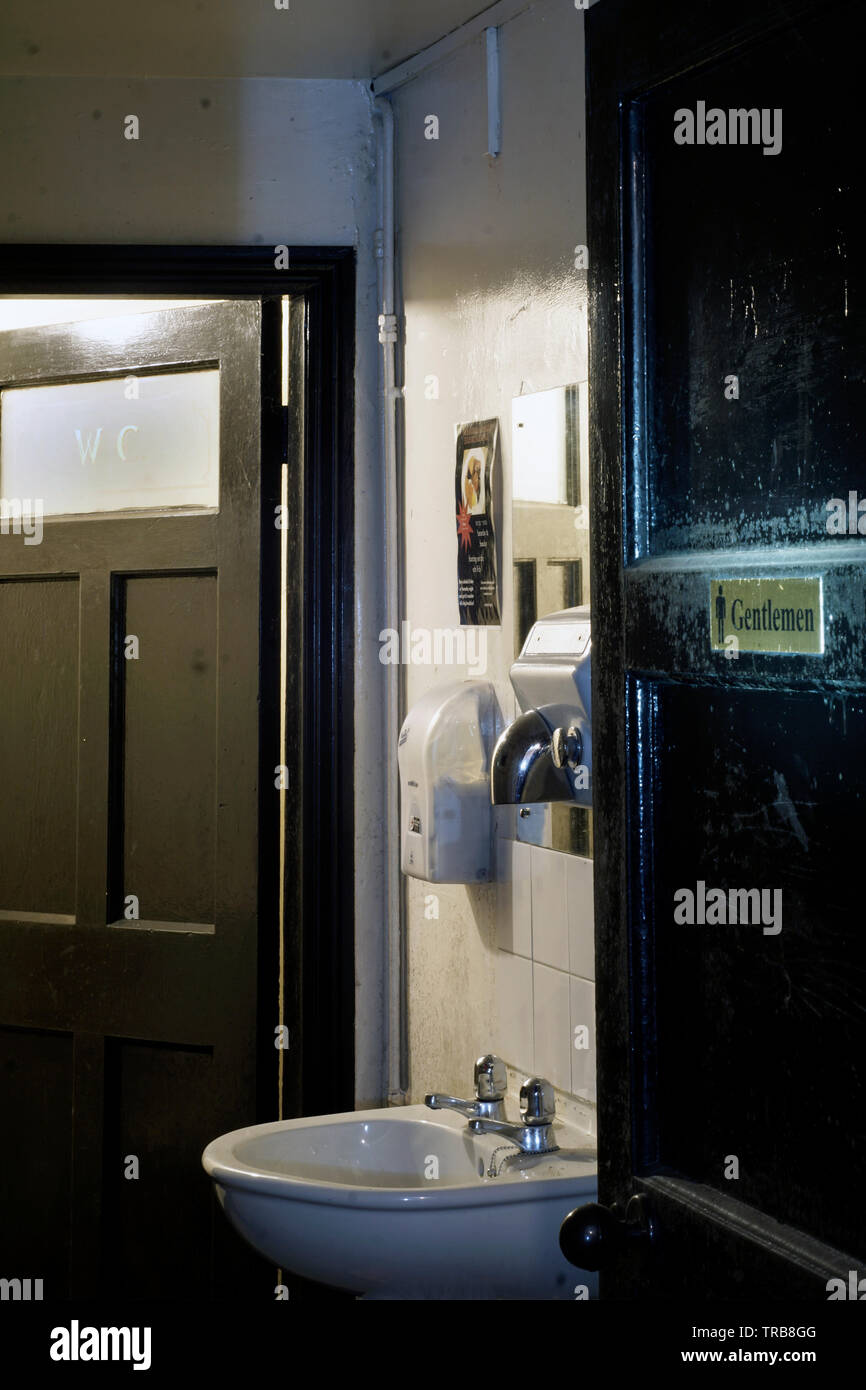 gents toilet in old pub Stock Photo