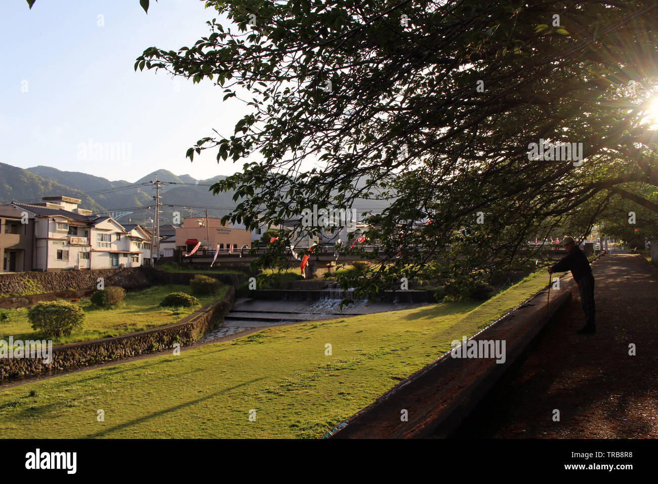 An old man with cane enjoying walk at one park in Beppu. Taken in Oita ...
