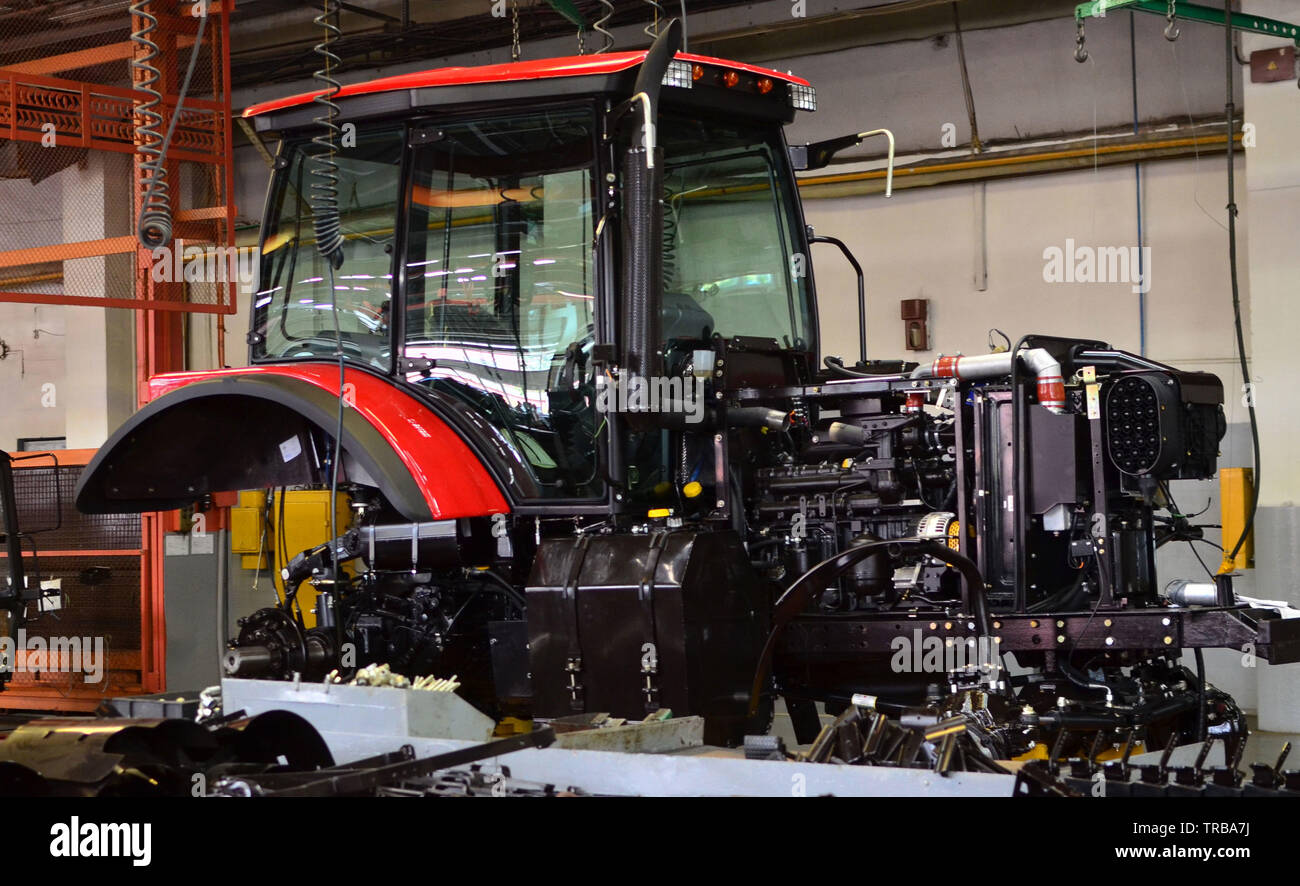 Tractor Manufacture work. Assembly line inside the agricultural