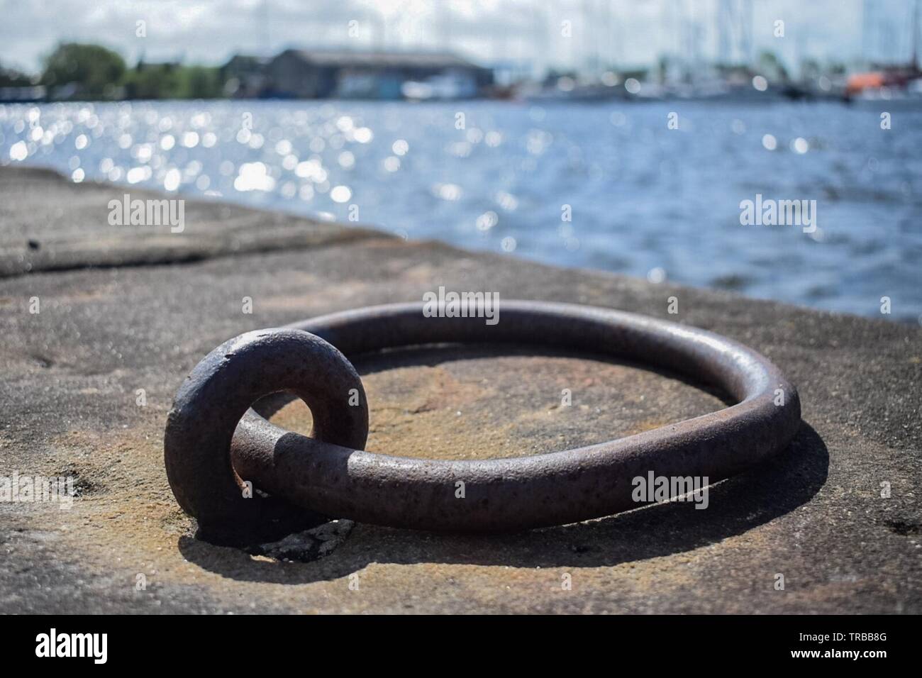 Old mooring ring at the docks Stock Photo