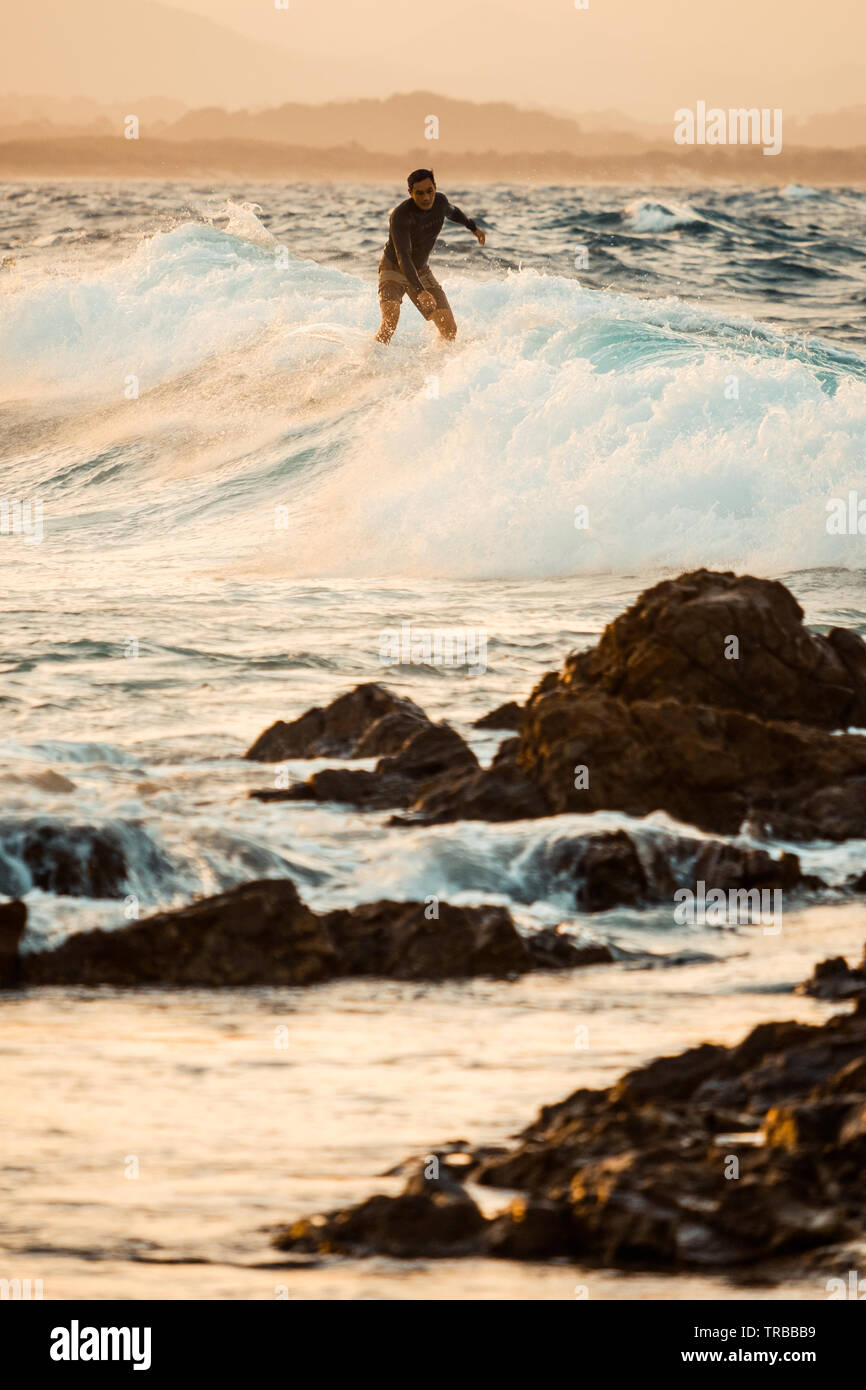 Surfers at Sunset in Byron Bay, NSW, Australia Stock Photo