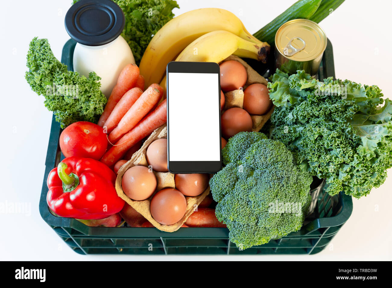 Food delivery service - smartphone on the box of groceries Stock Photo