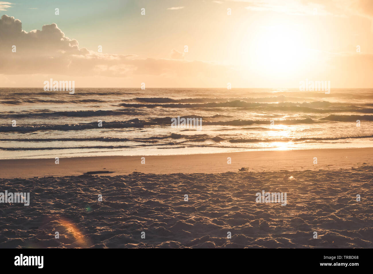 Beautiful sunset on the tropical beach with sky and clouds for travel ...