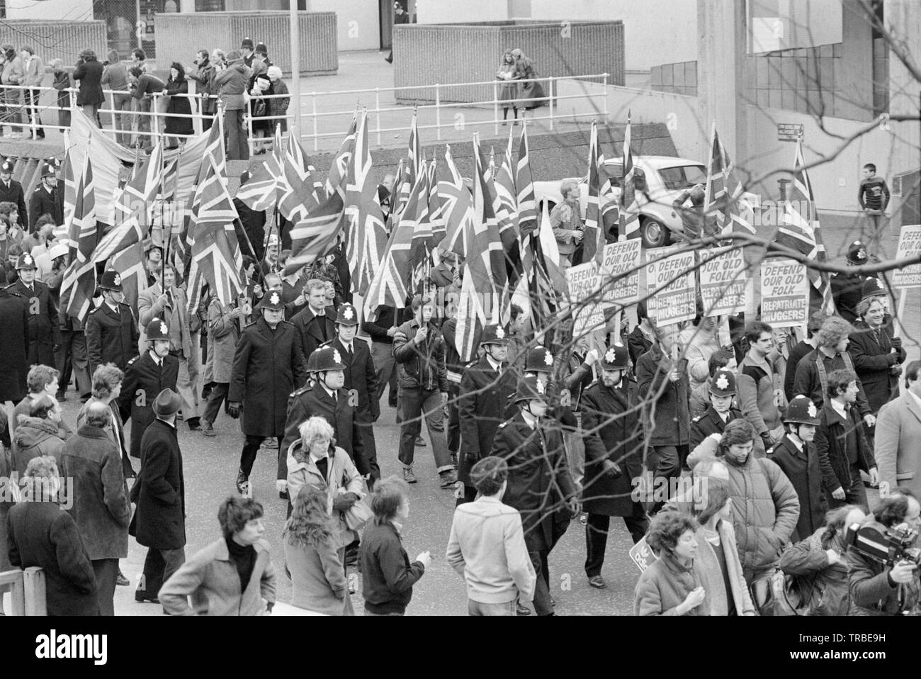 1980. A march by the National Front, a British Far Right Fascist Political Party, in Camberwell New Road, London, headed by its then leader Martin Webster. Banners proclaim 'Defend Our Old Folk' and 'Repatriate Muggers'. Stock Photo