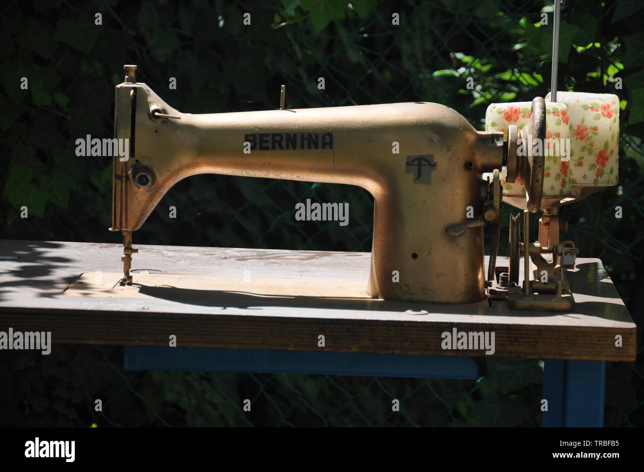 Old gold-colored sewing machine Stock Photo