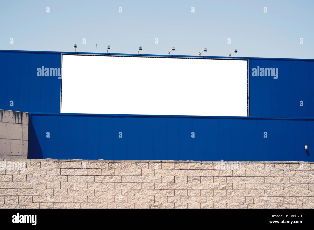 Blank advertising billboard in metallic frame with spotlight on blue ...