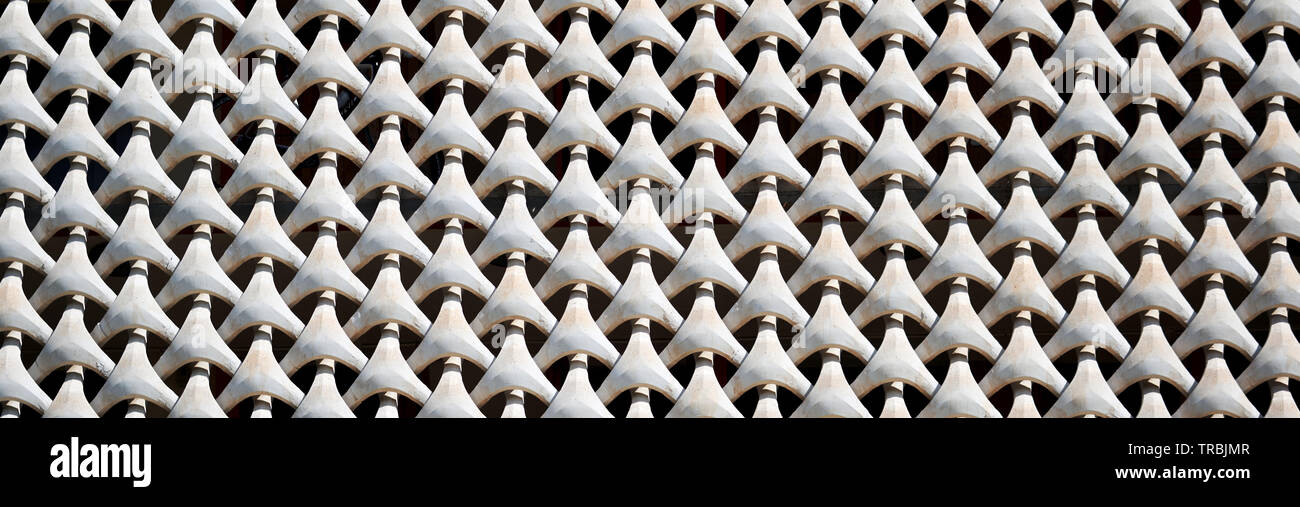 Close up of horizontal seamless pattern, concrete grate on the house facade. Full frame white color panoramic horizontal cropped image view Stock Photo