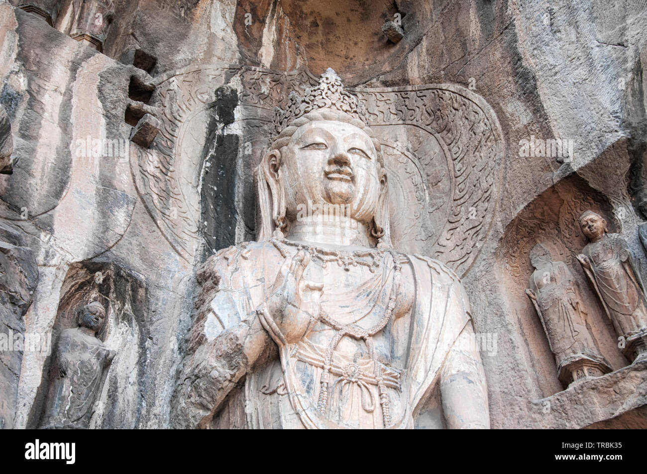 A weathered and ancient Buddha statue and carvings longmen grottoes in Luoyang China in Henan Province. Stock Photo