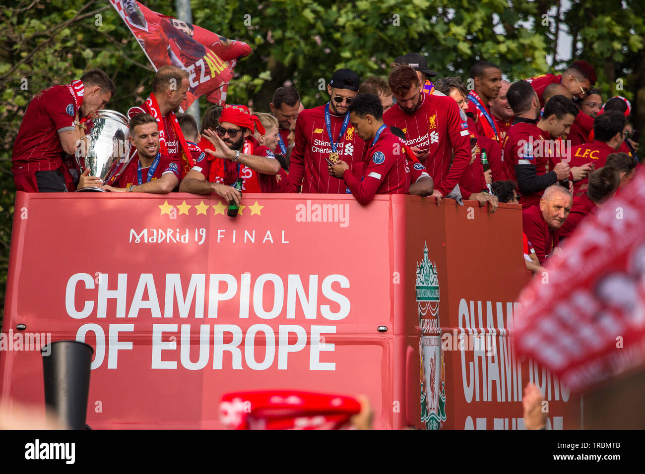 The players and management of Liverpool Football Club seen on an open top bus parading the Champions League trophy through the streets of Liverpool on Stock Photo