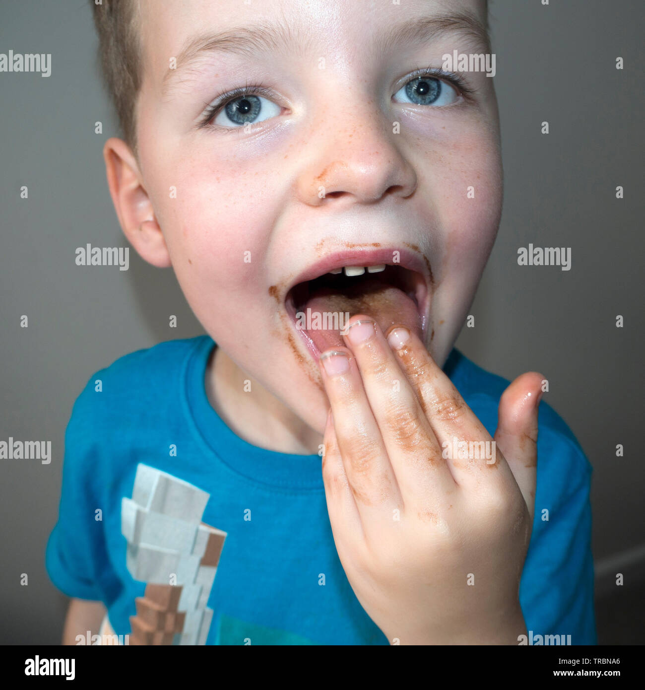 Young boy messing around at tea time Stock Photo - Alamy