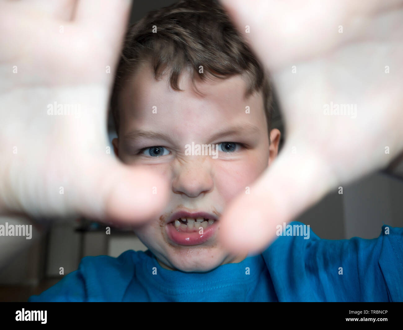 Young boy messing around at tea time Stock Photo - Alamy