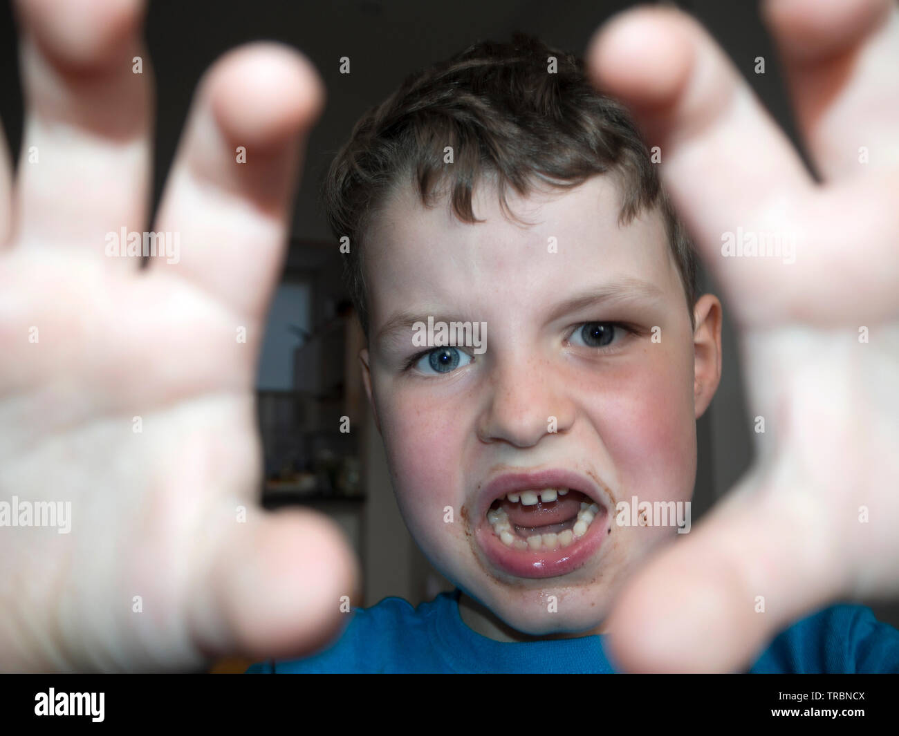 Young boy messing around at tea time Stock Photo - Alamy