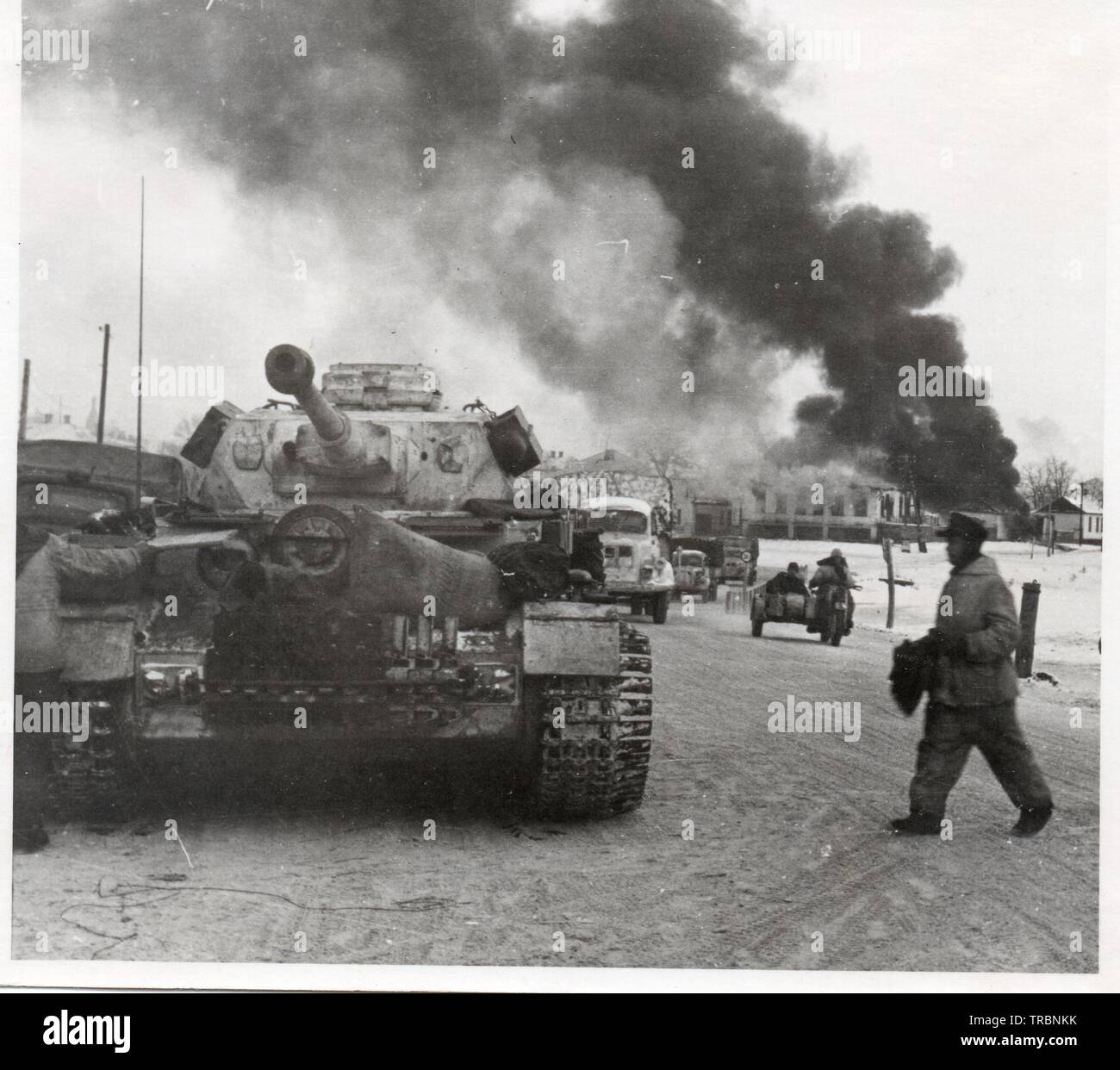 White painted German Panzer IV in burning Russian town 1943 Stock Photo