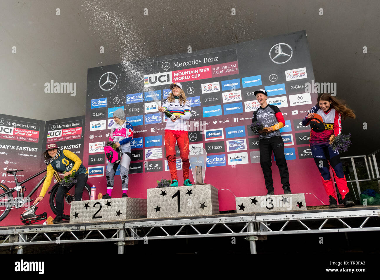 Fort William, Scotland, UK. 2nd June, 2019. UCI Mountain Bike World Cup - Rachel Atherton celebrating her victory in the Women's Elite Final. From left to right on the podium - Marine Cabirou (FRA), Tracey Hannah (AUS), Rachel Atherton (GBR), Nina Hoffmann (GER), Veronika Widmann (ITA) Credit: Kay Roxby/Alamy Live News Stock Photo