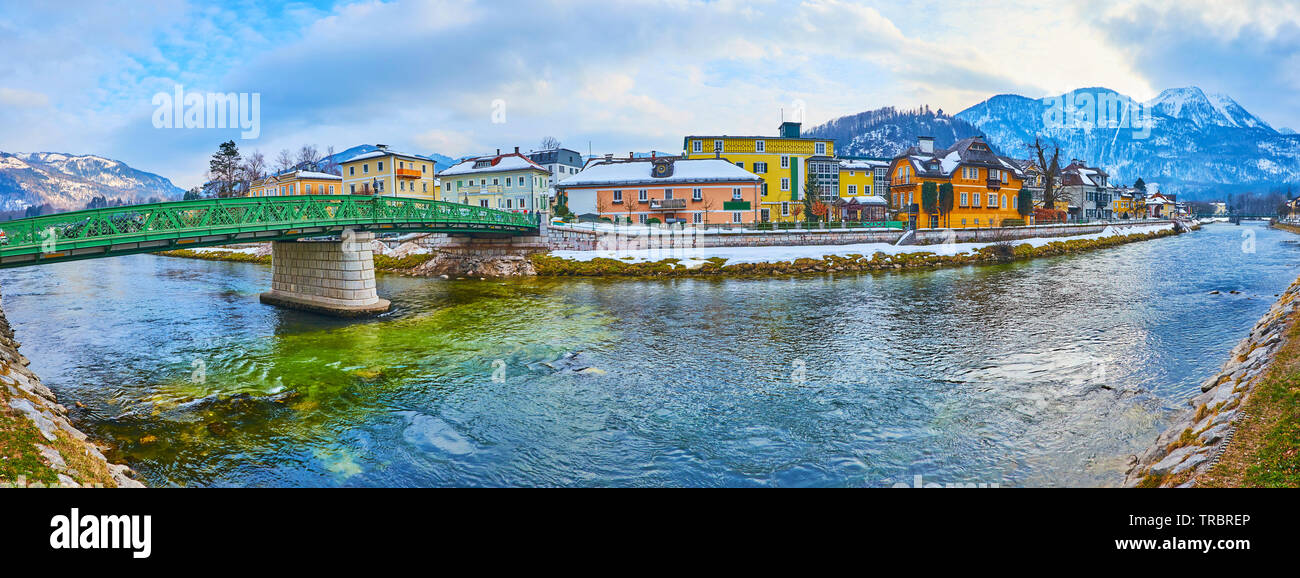 Walk by Traun river and enjoy the architecture of old town with bright green Elizabethbrucke bridge, colorful mansions, historic townhouses and snowy Stock Photo