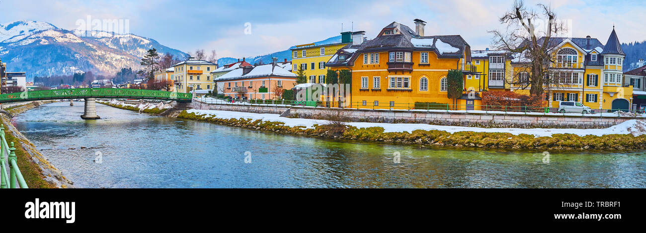 The beautiful Alpine town with preserved histroric mansions, winding Traun river, old bridges and snowy mountains on background, Bad Ischl, Salzkammer Stock Photo