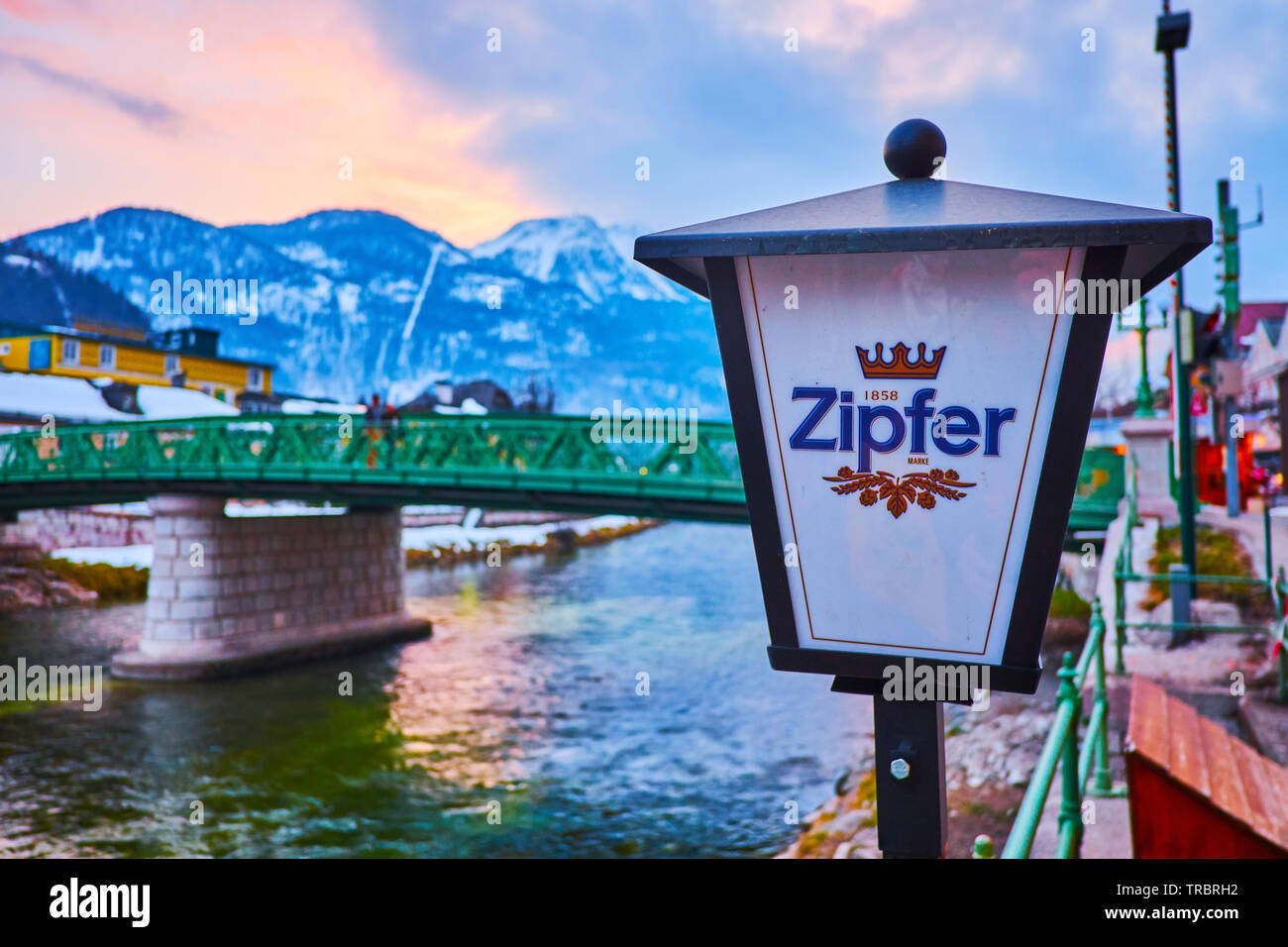 BAD ISCHL, AUSTRIA - FEBRUARY 20, 2019: The vintage lantern of Zipfer beer at the Elizabeth bridge across the Traun river in old town, on February 20 Stock Photo