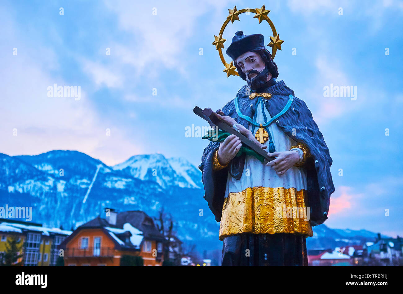 The close-up view of St Johannes Nepomuk statue in Bad Ischl with cloudy twilight sky on background, Salzkammergut, Austria Stock Photo