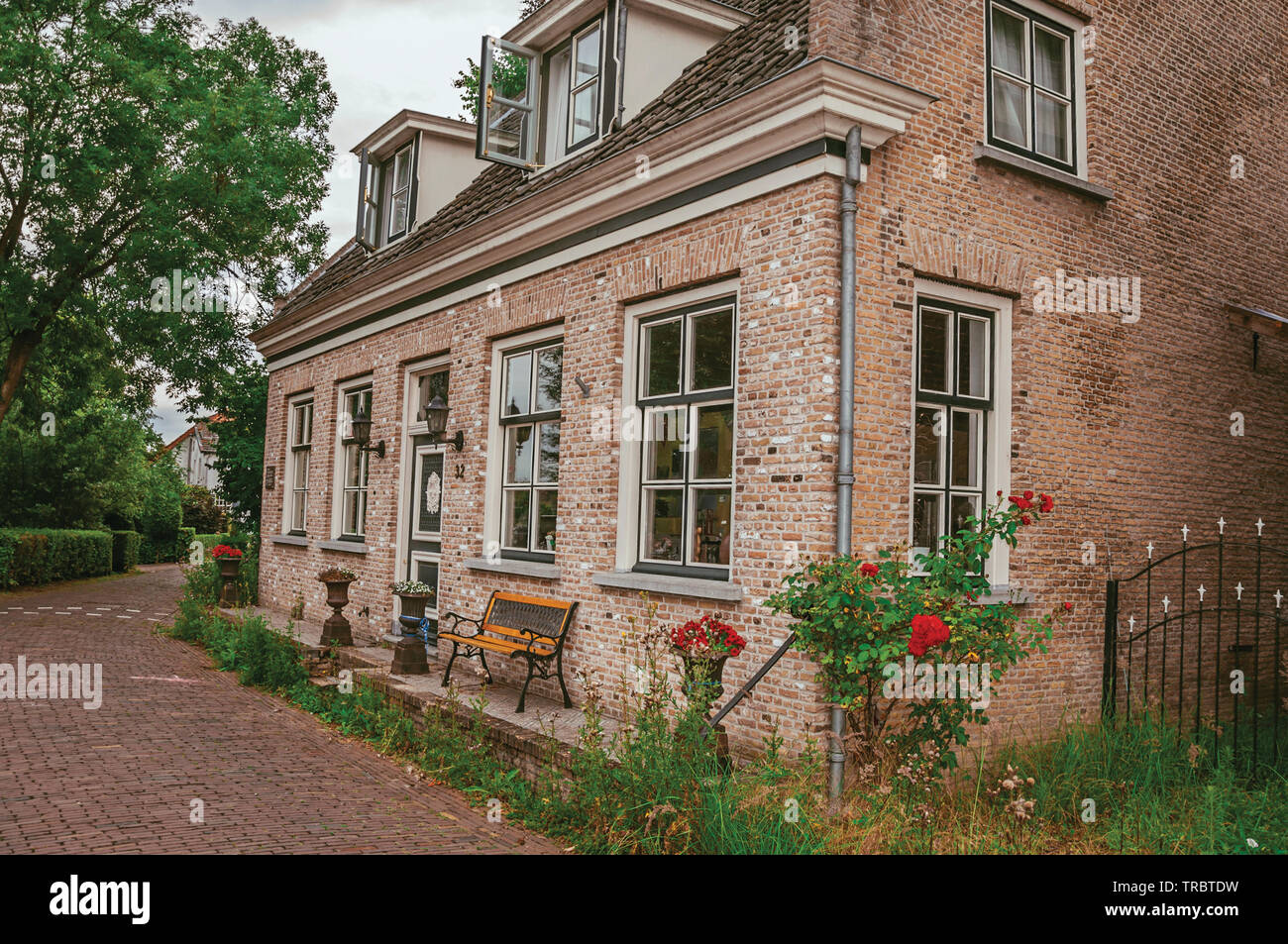 Charming And Quiet Alley With Brick Rustic Houses And Greenery At