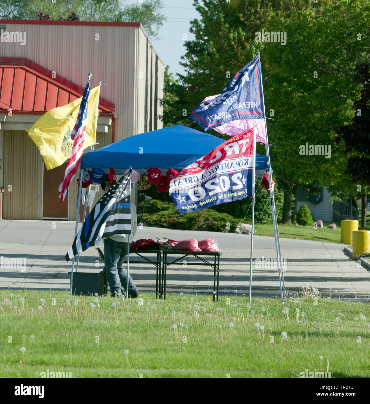 Manitowoc, Wisconsin USA, 2nd June, 2019.  Donald Trump 2020 reelection campaign getting off to an early start in Manitowoc.  Street vendor displays various American flags and Keep America Great Hats as well as campaign literature.   Credit: Jerome Wilson/Alamy Stock Photo