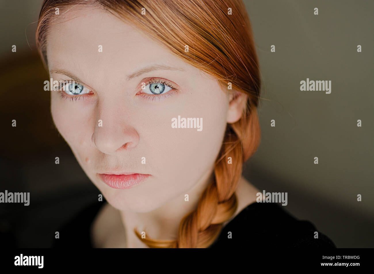 Face of a red hair girl who has a big blue eyes. Polish woman. Stock Photo
