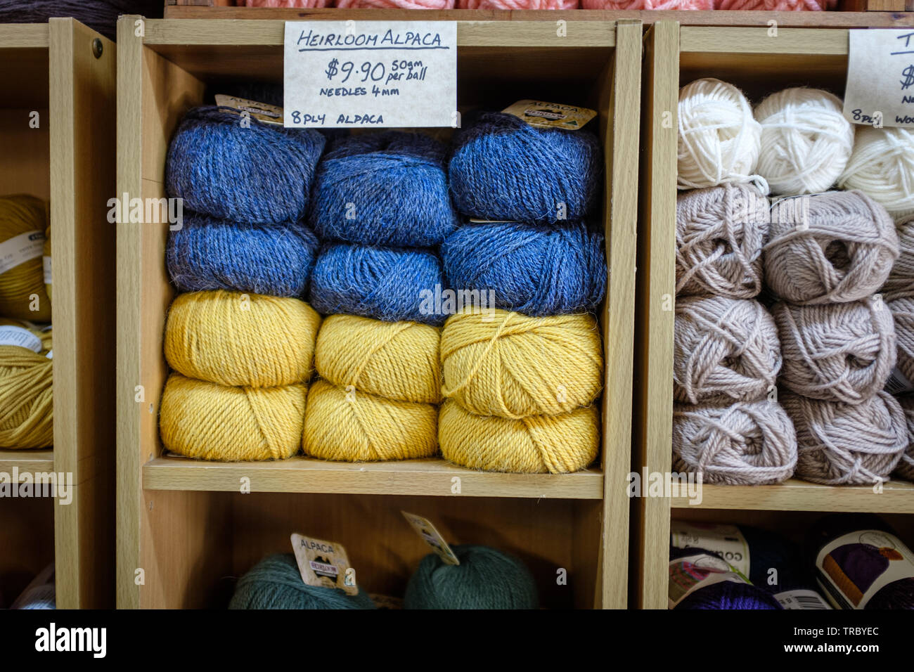 Colourful balls of Heirloom Alpaca wool piled up on shelf in craft shop Stock Photo
