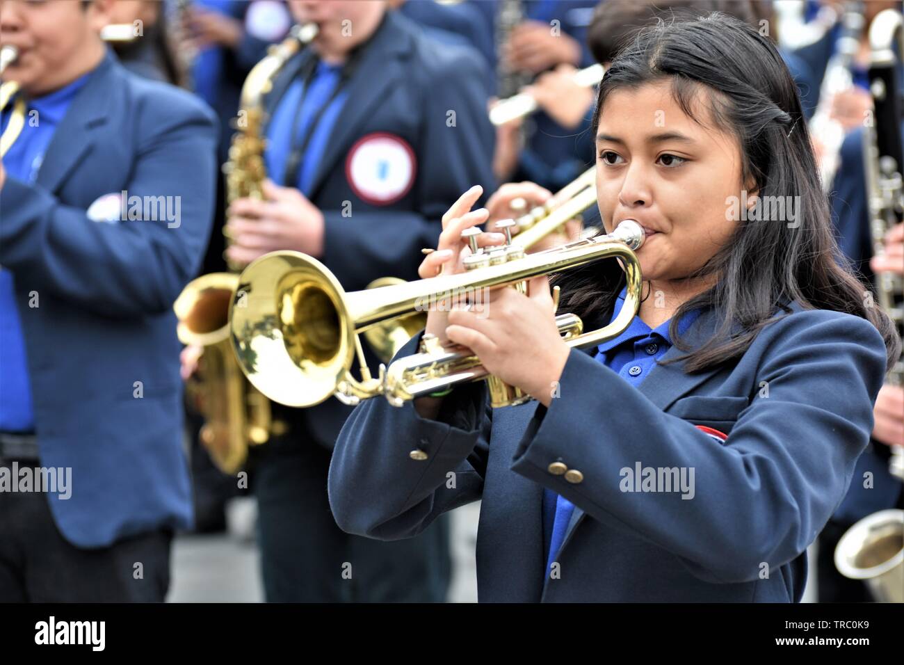 Hispanic kids who are members of California schools marching bands with instruments at Santa Maria parade Stock Photo