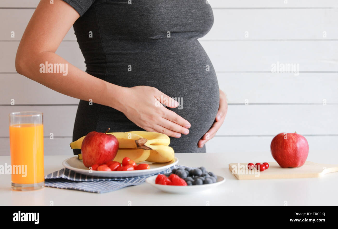 Pregnant woman drink orange fruit juice, healthy Stock Photo Alamy