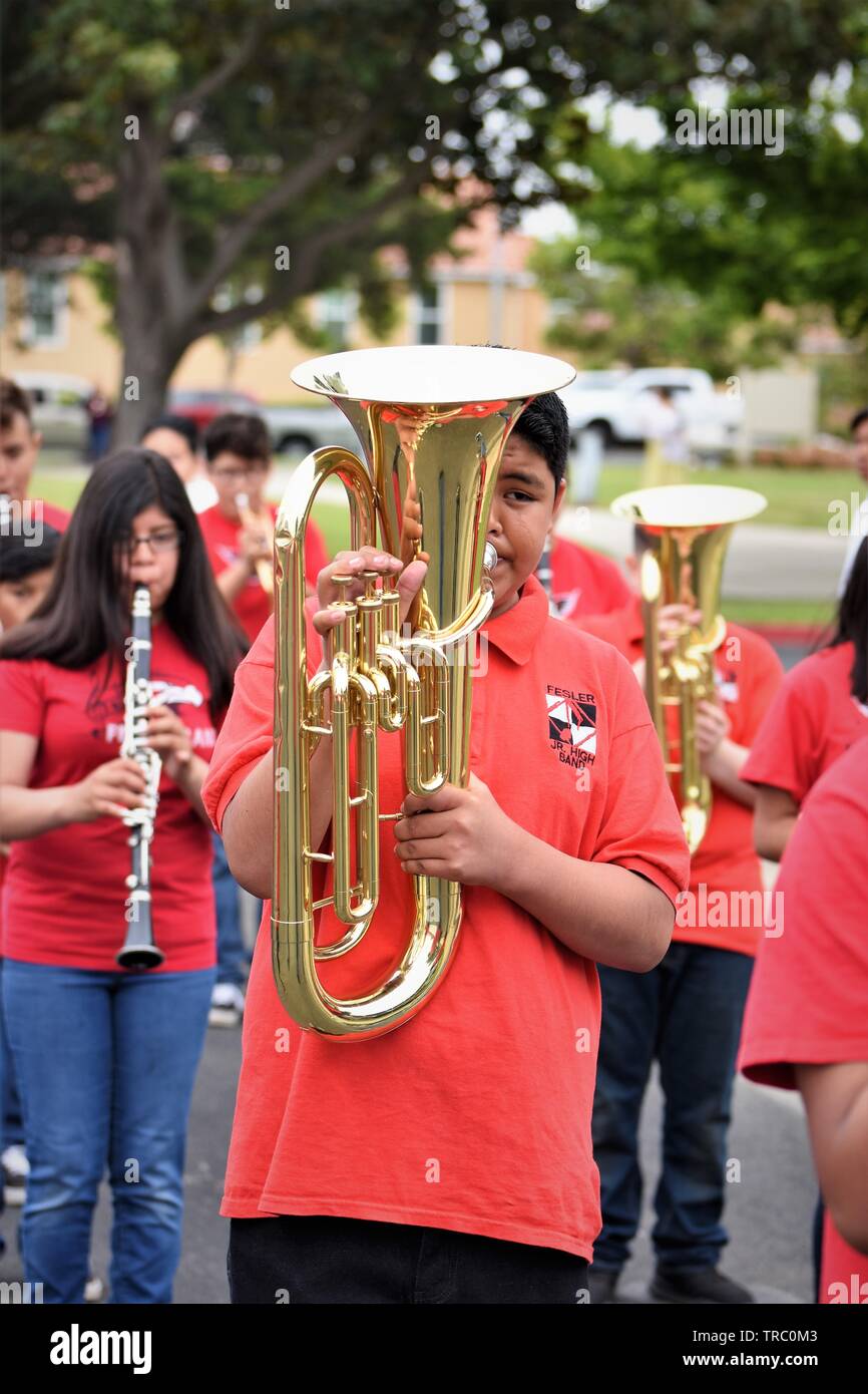 Hispanic kids who are members of California schools marching bands with instruments at Santa Maria parade Stock Photo