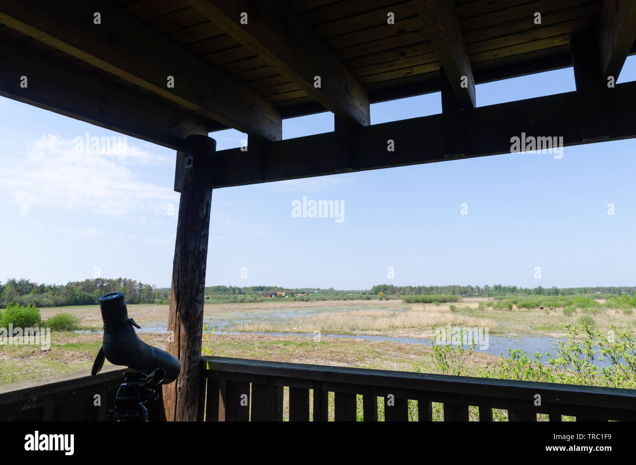 Spotting scope on a tripod in a bird watching tower with view over a wetland at the swedish island Oland Stock Photo