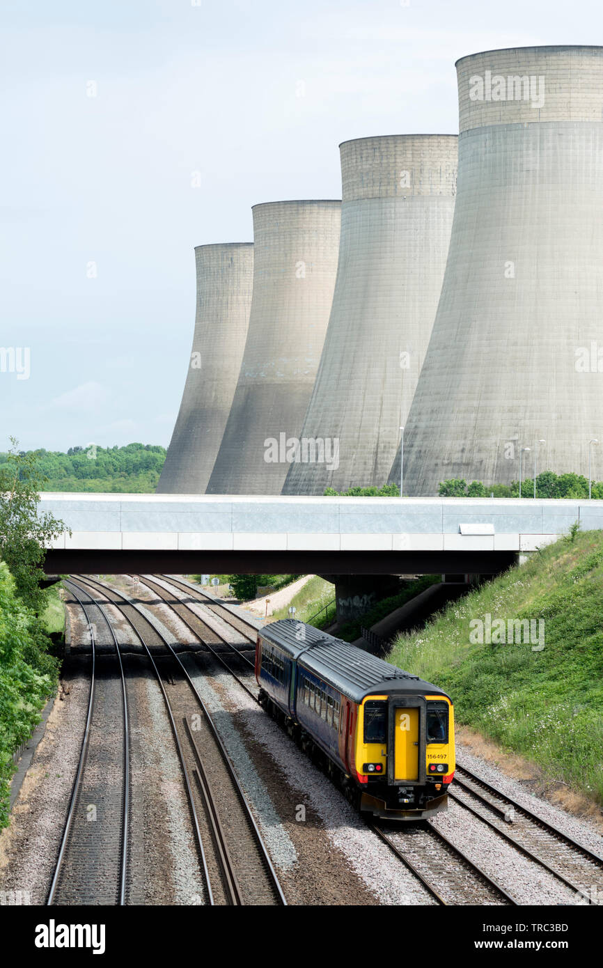 East Midlands class 156 diesel train passing Ratcliffe Power Station, Nottinghamshire, England, UK Stock Photo