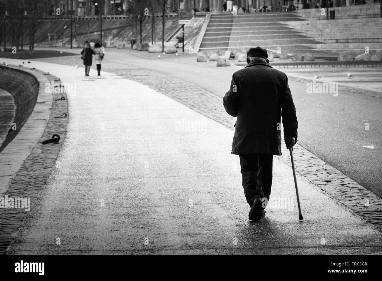 Old back man with his cane walking on the docks Stock Photo - Alamy