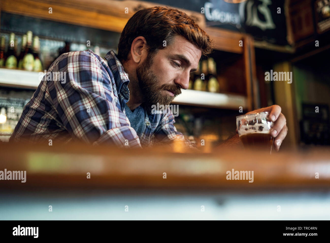 Sad man sitting in beer bar Stock Photo - Alamy