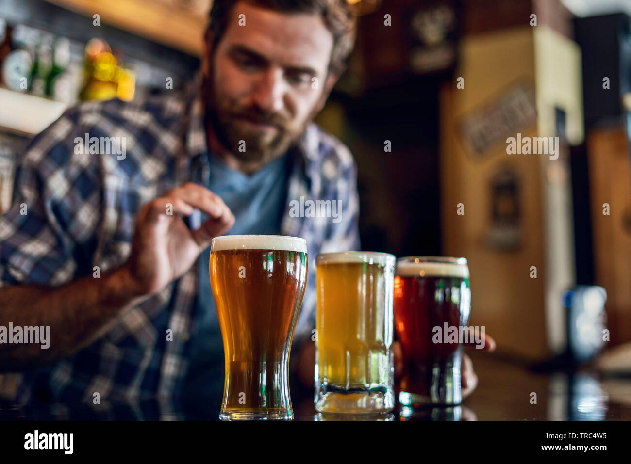 Man looking at beer glass Stock Photo Alamy