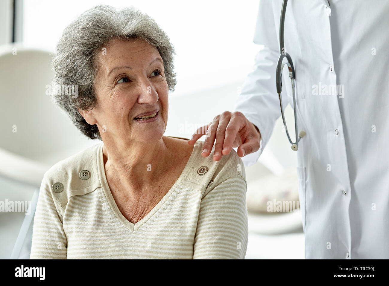 Senior female doctor standing hi-res stock photography and images - Alamy