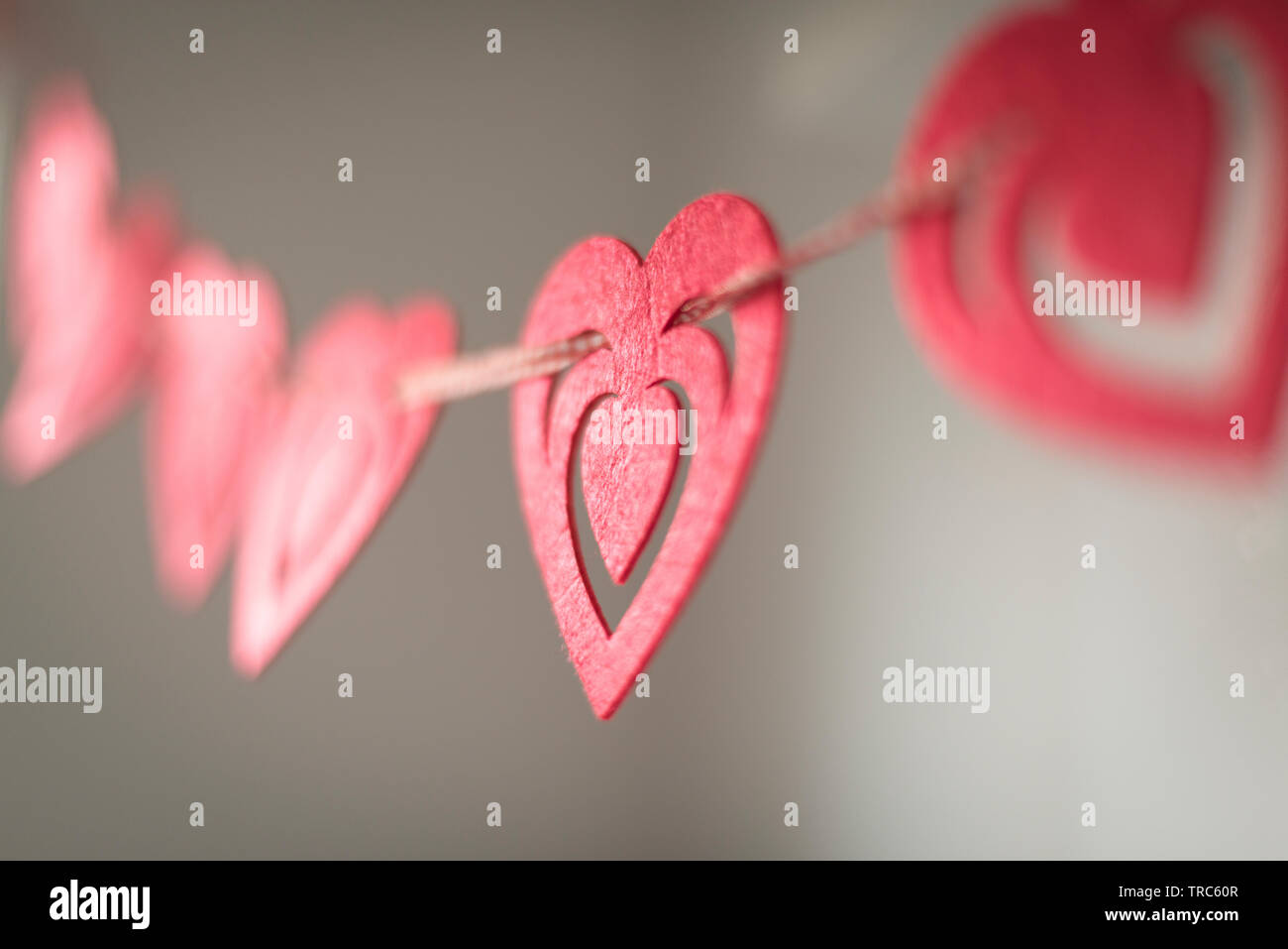 Red heart shaped card peg holder- selective focus Stock Photo
