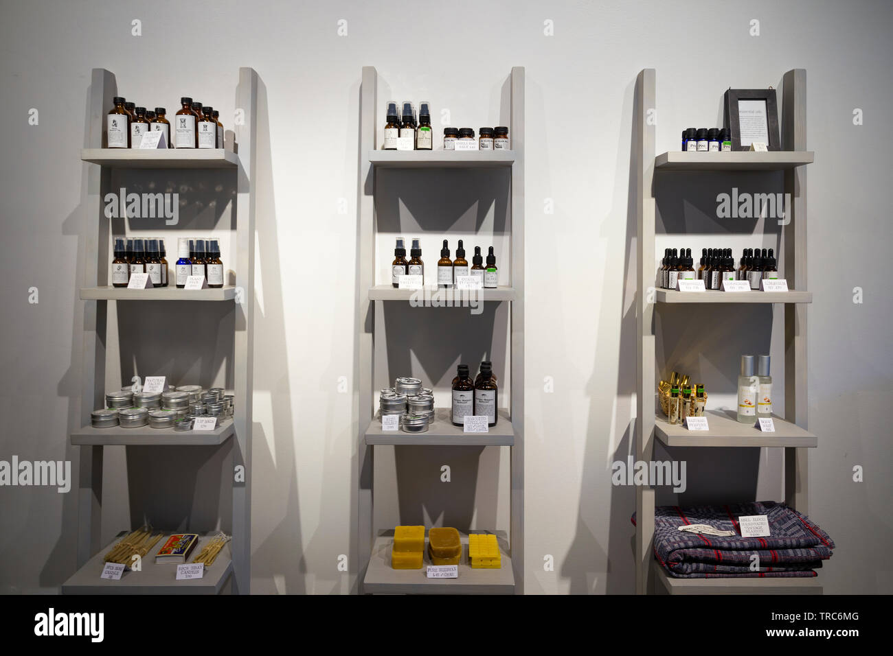 Manila, Philippines - August, 4, 2016: Grey shelves in a shop full of bottles with natural organic products Stock Photo