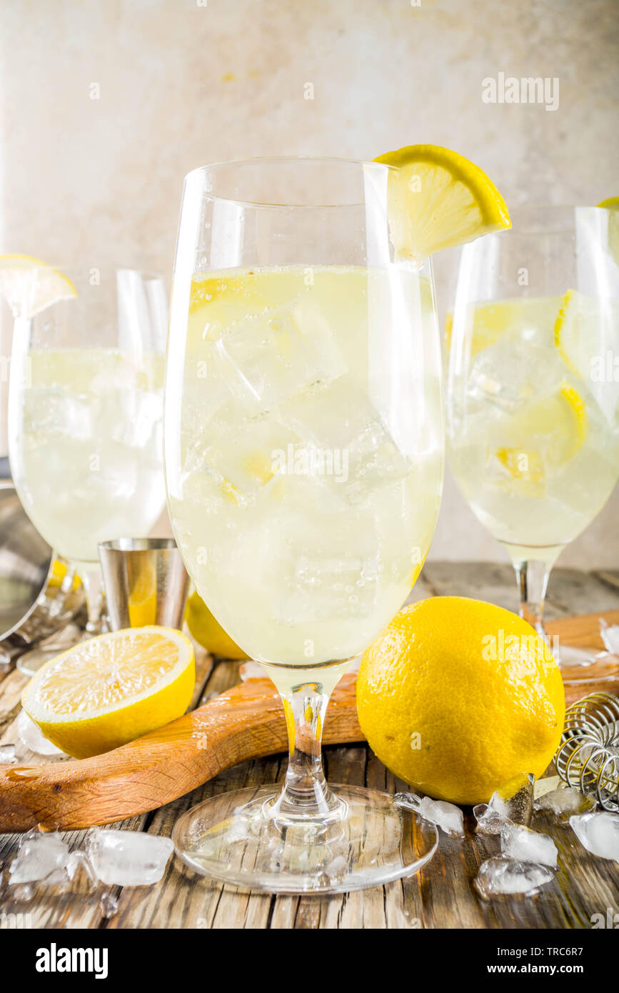 Trendy summer cold drink. St Germain French Spritz cocktail with lemon  slices, old rustic wooden background copy space Stock Photo - Alamy