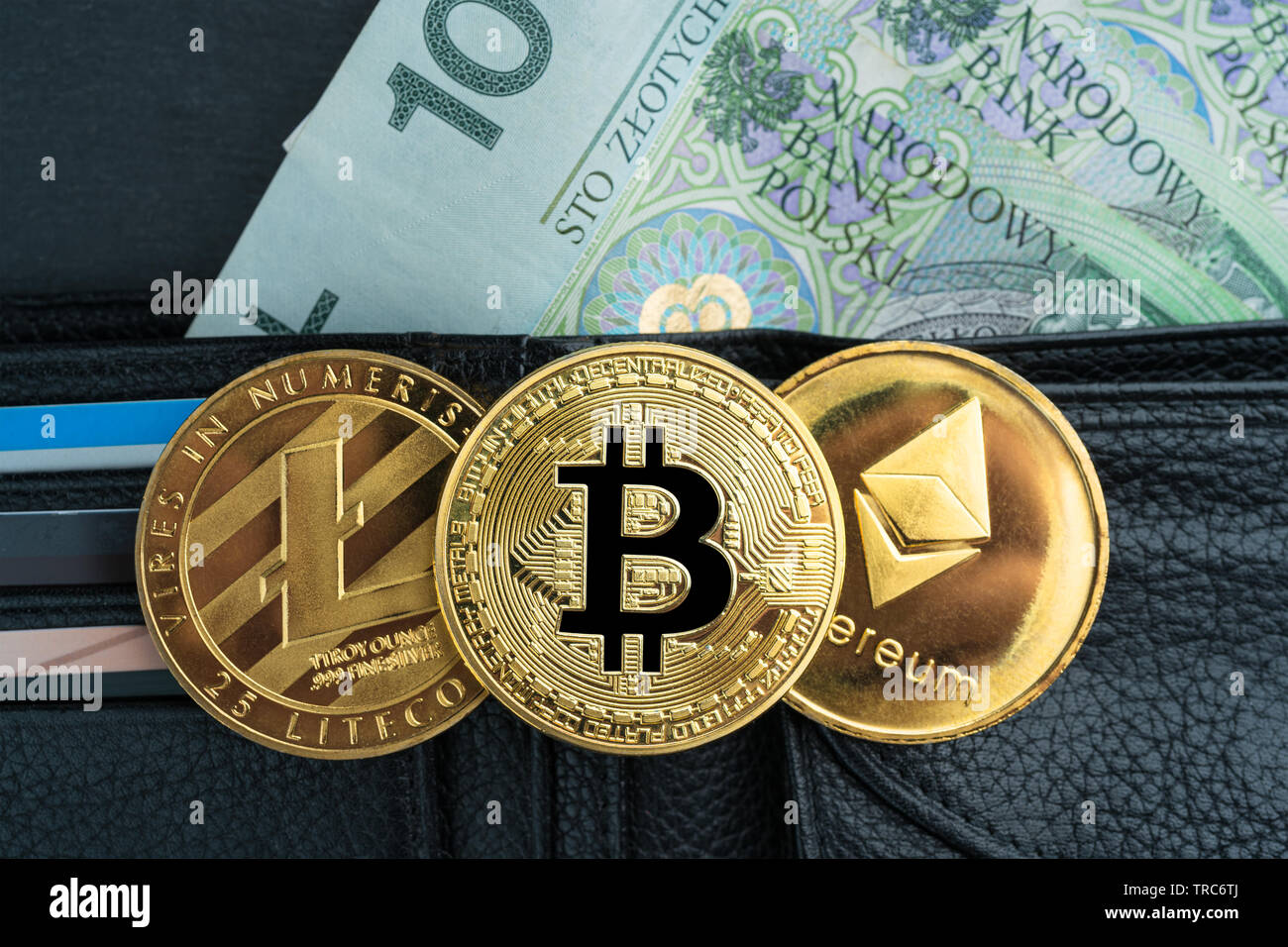 Physical Bitcoin, Litecoin and Ethereum gold coins with polish currency (PLN)  on a black stone slate plate with chain. Cryptocurrency exchange abstrac  Stock Photo - Alamy